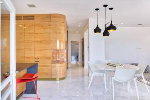 a kitchen and dining room with a table and chairs at New renovated APT, HaYarkon in front of the beach in Tel Aviv
