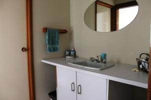 a bathroom with a sink and a mirror at Family Holiday House with Open Plan Living in Cowes +15 photos