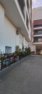 a building with tables and chairs on a balcony at Logement Chic, résidence azaléa - Alger in Draria