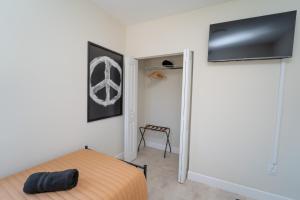 a bedroom with a bed and a flat screen tv at Miami Luxury Vacation! Next to Wynwood & Design district in Miami