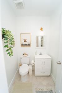 a bathroom with a white toilet and a sink at Miami Luxury Vacation! Next to Wynwood & Design district in Miami