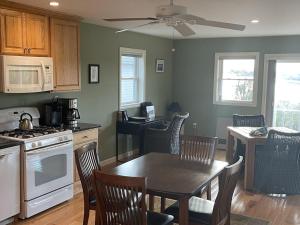 a kitchen with a table and chairs and a dining room at Spindrift in Eastport