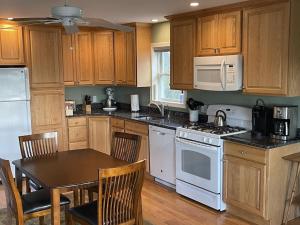 a kitchen with a table and a white stove top oven at Spindrift in Eastport