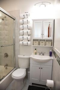 a bathroom with a toilet and a sink and a shower at The Harlem Getaway in New York