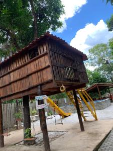 a tree house with a slide in a playground at Suíte Rio de Ondas 1 in Barreiras