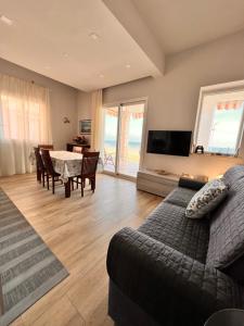 a living room with a couch and a table at Aria in Marina di Palma