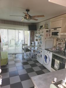 a kitchen with a checkered floor at les oliviers in Veigné