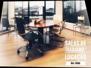 a table in an office with chairs around it at Hotel Germânia in Joinville