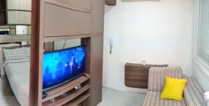 a living room with a tv and a couch at Belo Exclusivo AP Com Garagem na Cidade Baixa Próximo a Santa Casa, UFRGS e Centro Histórico - BnB Serviços Inteligentes Por Fioravante in Porto Alegre