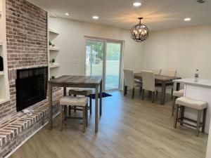 a living room with a fireplace and a table and chairs at ZenHomes in Brandon near Tampa Valrico Seffner in Brandon