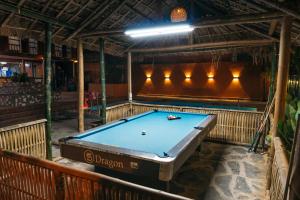 a pool table in the middle of a room at Odyssey Hostel, Tours & Motorbikes Rental in Ha Giang