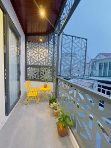 a patio with two chairs and a table on a balcony at Lamy House in Can Tho