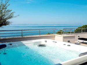 a hot tub on a balcony with a view of the ocean at Penthouse The One in Split