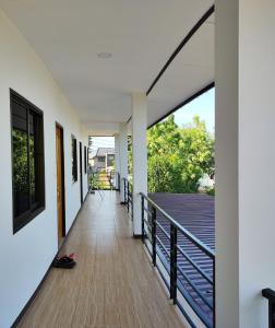 a corridor of a house with a balcony at Dowslom Place in Ban Phayun