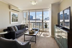 a living room with a couch and a table at StayCentral - Cityside on Whiteman Street Southbank in Melbourne