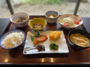 a table topped with plates of food and bowls of food at Hotel Nakamuraya in Shiojiri