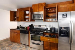 a kitchen with stainless steel appliances and wooden cabinets at Upscale 2BR Apartment with Patio in Washington