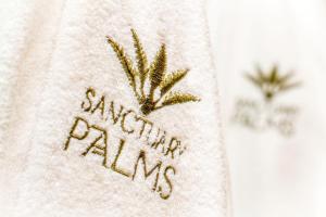a towel with the words santa palm written on it at Sanctuary Palms in Paihia