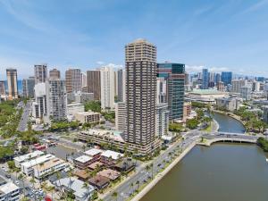 an aerial view of a city with a river and buildings at Hawaiian Monarch Penthouse 104 by Hawaii Ocean Club in Honolulu