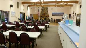 a dining room with tables and chairs and a cafeteria at Preferred RV Resort in Pahrump