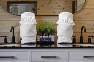 a pair of white boots and socks on a sink at Modern Riverfront, Starlink, Hot Tub, Broken Bow in Wright City +50 photos