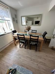 a dining room with a table and chairs at Ty Pentref - Cwmcarn Village House in Cwmcarn