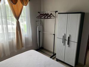 a bedroom with a white bed and a window at Casa RODME in Fortuna