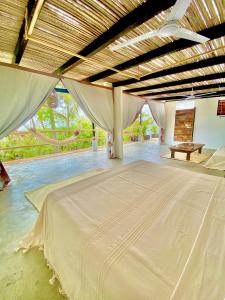 a large room with a large bed in it at El Eden Escondido in Puerto Escondido