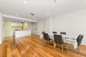 a dining room with a table and chairs at Belle Escapes - Lazy Days on Colley Terrace in Glenelg