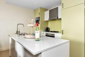 a kitchen with a bottle of wine on a counter at Belle Escapes - Olive Retreat at Glenelg in Glenelg