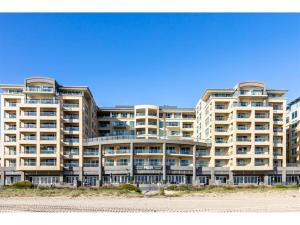 a large apartment building on the beach in front of the ocean at Belle Escapes - Absolute Ocean Views in Glenelg