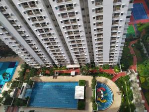 an overhead view of a large apartment building with a swimming pool at Spacious & Cozy 27FL - 2BR Apartment West Jakarta in Jakarta