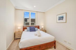 a bedroom with a large bed and a window at Chelsea Terrace in Newcastle