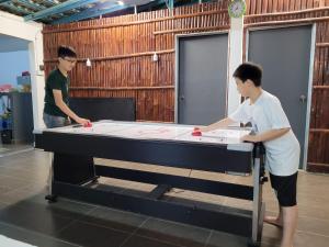 two men standing next to a pool table at Lipis Riverfront Resort in Kuala Lipis +50 photos