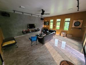 an aerial view of a living room with a couch and chairs at Lipis Riverfront Resort in Kuala Lipis