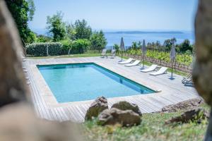 a swimming pool with lounge chairs and umbrellas at Relais du vieux sauvaire in Le Lavandou