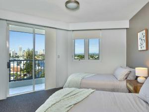 a bedroom with two beds and a large window at Quiet location close to it all in Gold Coast