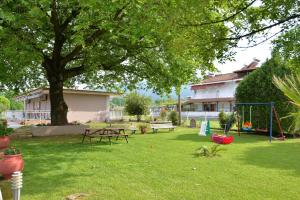 a park with a picnic table and a playground at Studios Λύδια in Paralía Skotínis