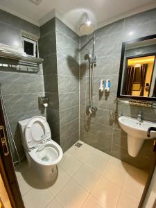 a bathroom with a toilet and a sink at NEW SKY AIRPORT HOTEL NỘI BÀI in Noi Bai