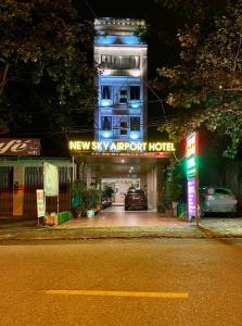 a new six apartment hotel with a car garage at night at NEW SKY AIRPORT HOTEL NỘI BÀI in Noi Bai
