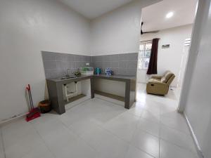 a kitchen with a table and a chair in a room at Homestay Mama, KB in Kota Bharu