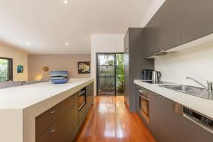 a kitchen with a sink and a counter top at At Lizzie in Elizabeth Beach