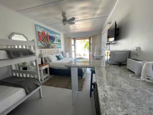 a bedroom with two bunk beds and a desk in it at Happy Waves Holiday Home in Jeffreys Bay