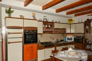 een keuken met witte kasten en een tafel met een tafel sidx sidx bij Chalet del paese Incantato in Moncenisio