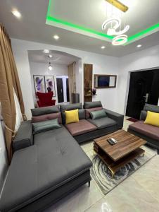 a living room with a couch and a coffee table at Melford Homes in Lagos