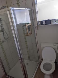 a bathroom with a shower and a toilet at Large garden block with multiple dwellings in the centre of Bendigo in Bendigo