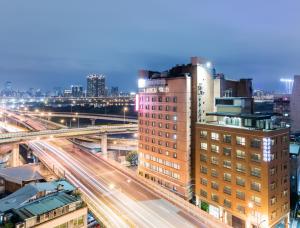 a view of a city with buildings and trains at Hotel Riverview Taipei in Taipei
