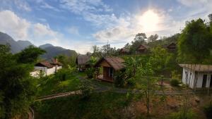 an aerial view of a village in the mountains at Naga Lodge in Luang Prabang