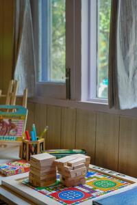 a childs play area with wooden toys on a table at SaffronStays The Elements in Kulu