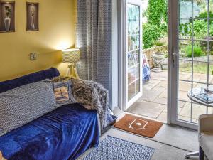 a bedroom with a bed and a sliding glass door at Sams Snug in Birchington